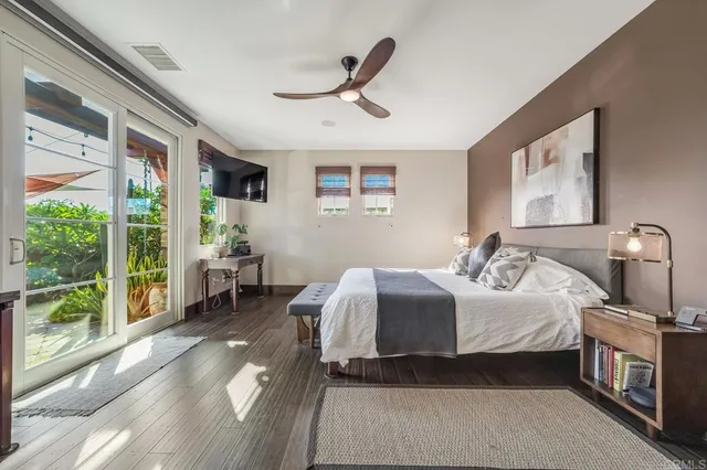 a bedroom with a bed and a large window