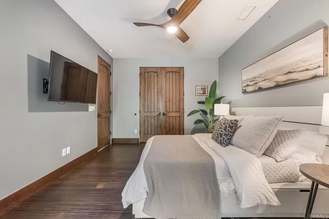 a bedroom with a bed and a flat screen tv