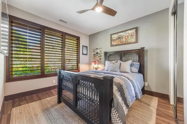 a bed sitting in a bedroom next to a window