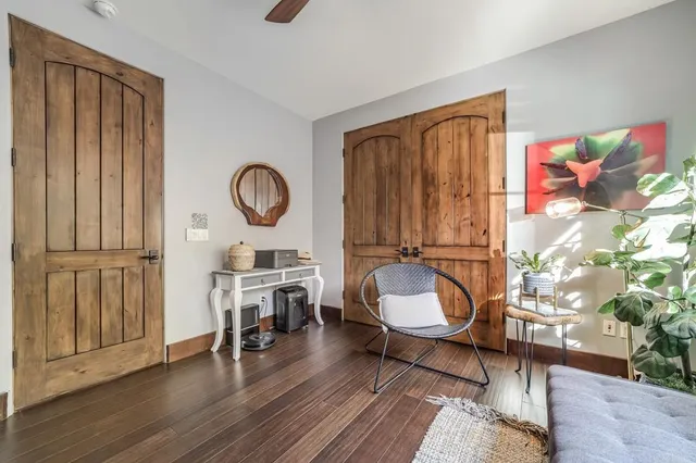 a living room with furniture a window and wooden floor
