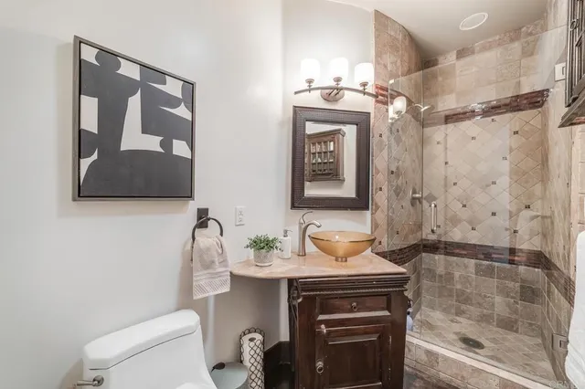 a bathroom with a sink a toilet and shower