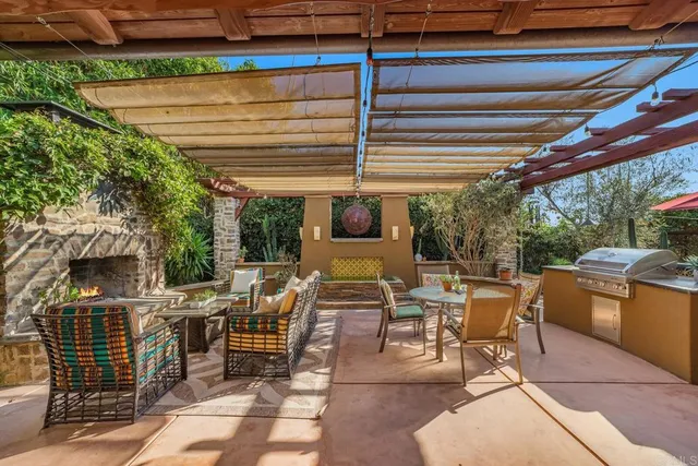 a view of a patio with a dining table and chairs with wooden floor