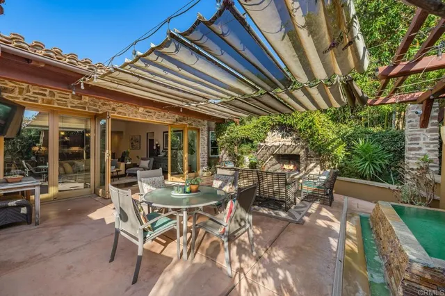 a view of a patio with table and chairs and potted plants