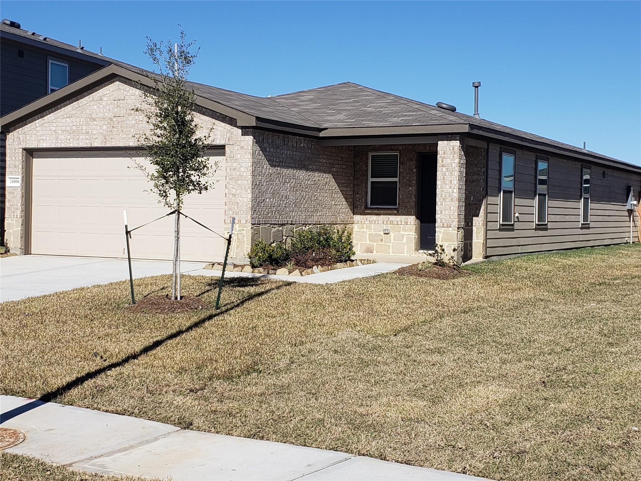 24006 Swather Way Hockley, TX 77447 - Photo 2 of 20 a front view of a house with garden