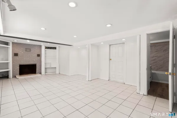 a view of an empty room with a fireplace