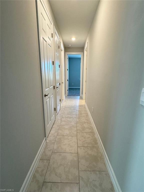 926 Enbrook Loop Naples, FL 34114 - Photo 14 of 24 Corridor featuring baseboards