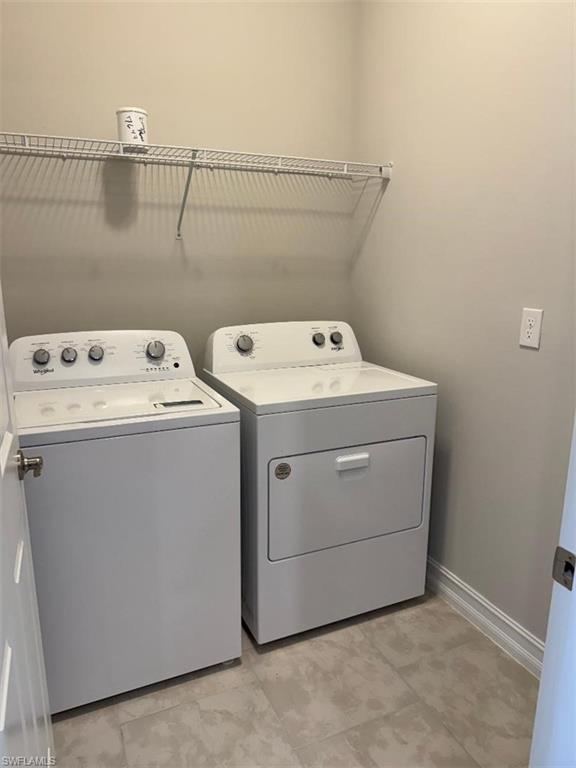 926 Enbrook Loop Naples, FL 34114 - Photo 15 of 24 Laundry area with baseboards, laundry area, and washing machine and clothes dryer