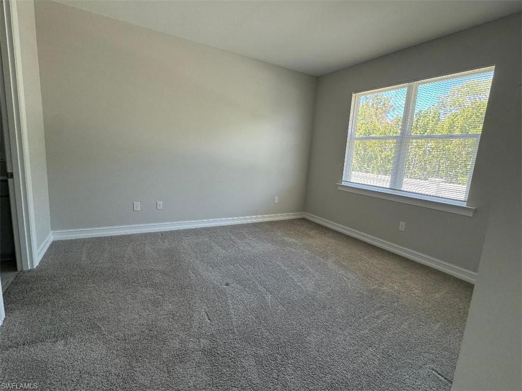 926 Enbrook Loop Naples, FL 34114 - Photo 21 of 24 Spare room with baseboards and carpet floors