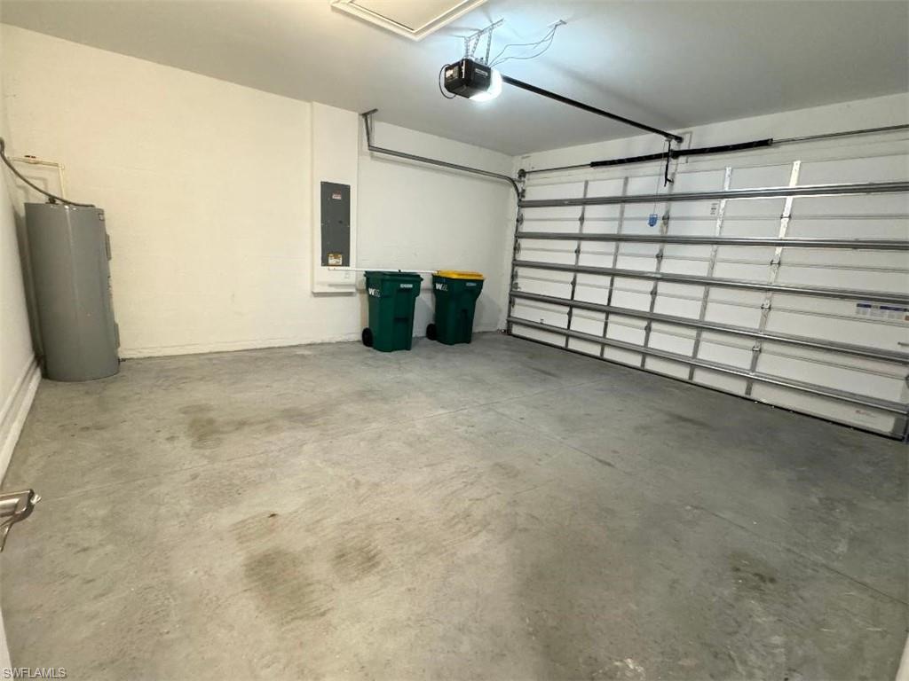 926 Enbrook Loop Naples, FL 34114 - Photo 24 of 24 Garage with electric panel, water heater, and a garage door opener