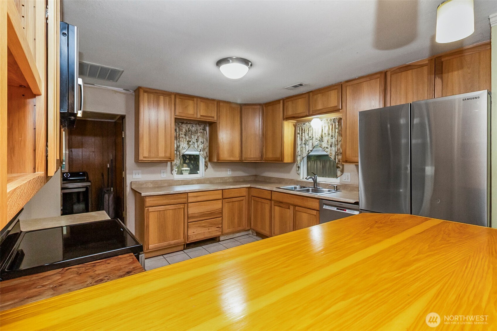 335 North Madison Street Monroe, WA 98272 - Photo 19 of 38 a kitchen with stainless steel appliances granite countertop a sink refrigerator and cabinets
