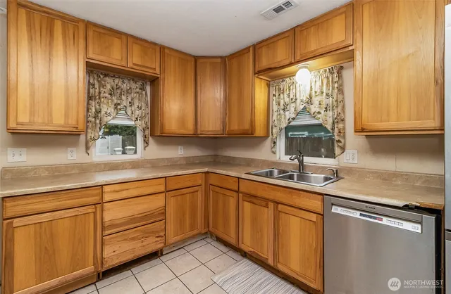 a kitchen with a sink appliances and cabinets