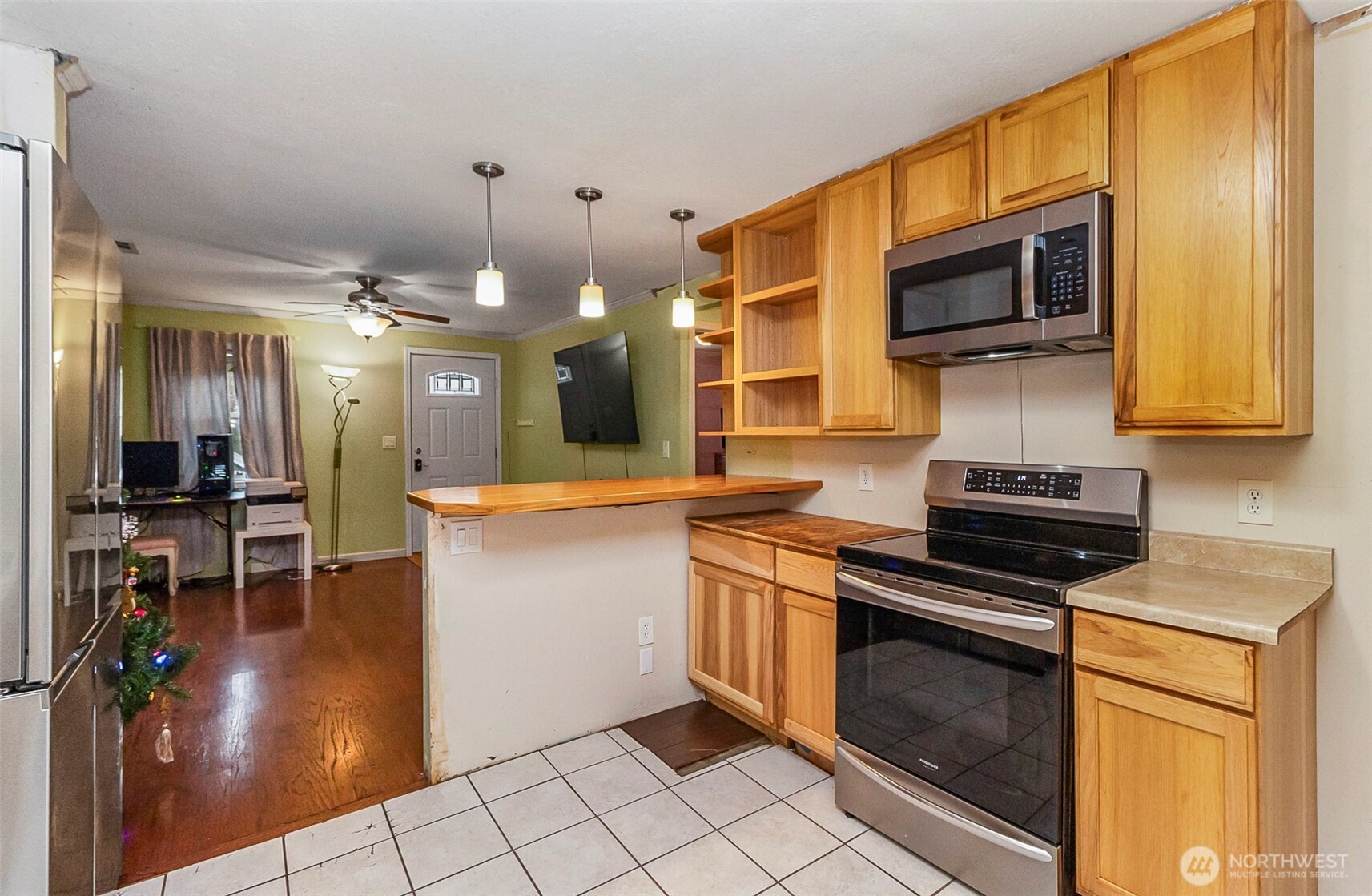 335 North Madison Street Monroe, WA 98272 - Photo 23 of 38 a kitchen with stainless steel appliances granite countertop a stove a sink and a microwave