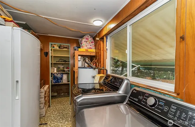 a bedroom with a bed and a flat tv screen on dresser