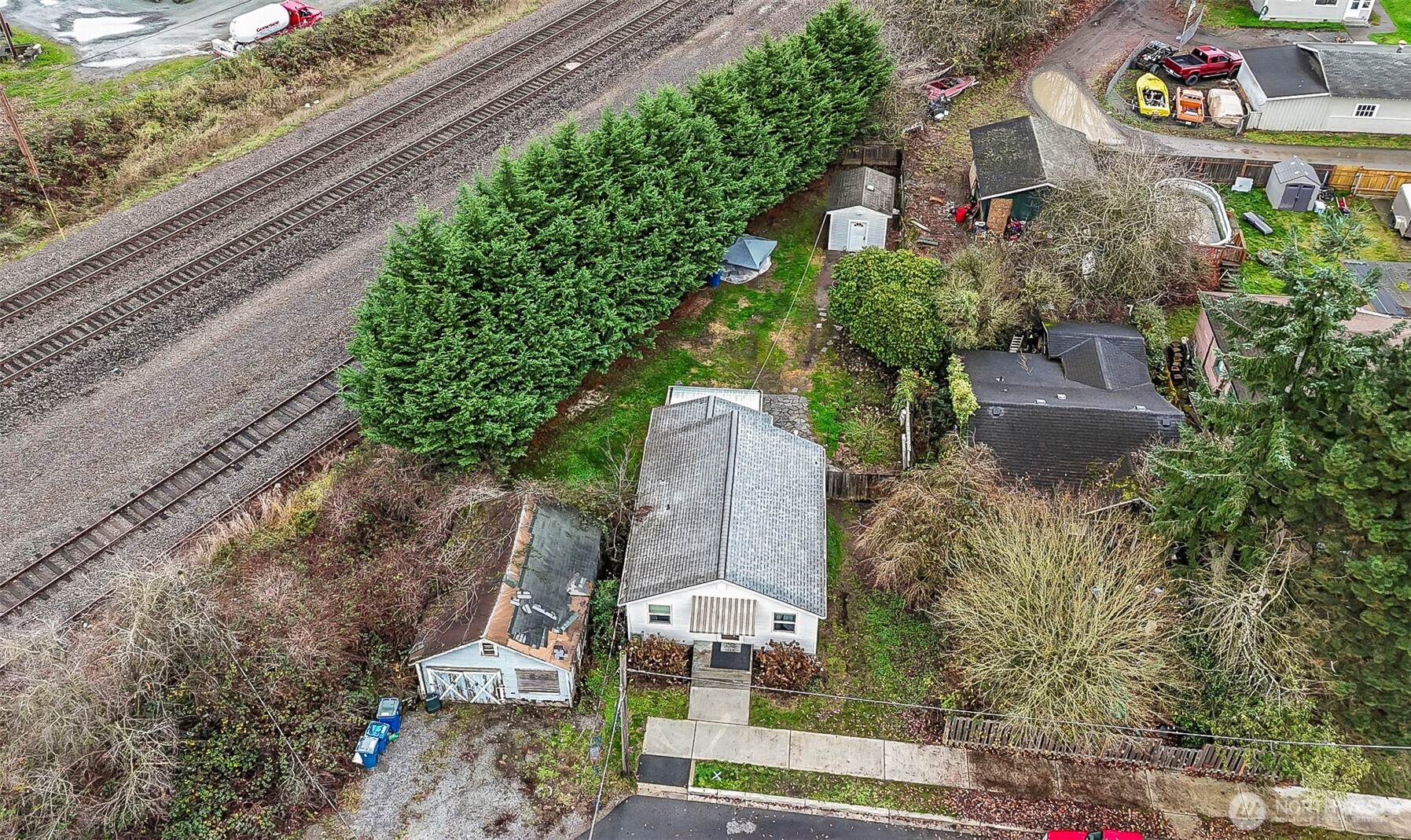 335 North Madison Street Monroe, WA 98272 - Photo 30 of 38 a aerial view of a house with a yard and large trees