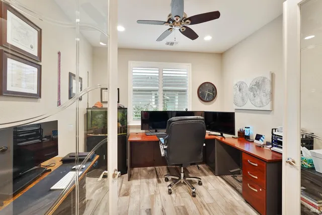 a view of a workspace with furniture and a window