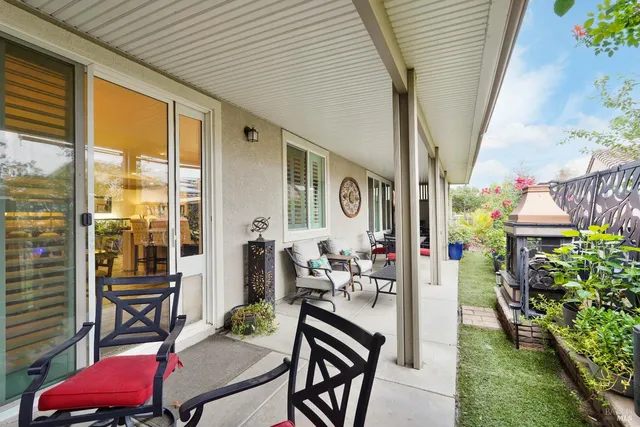 a outdoor dining space with furniture and garden view