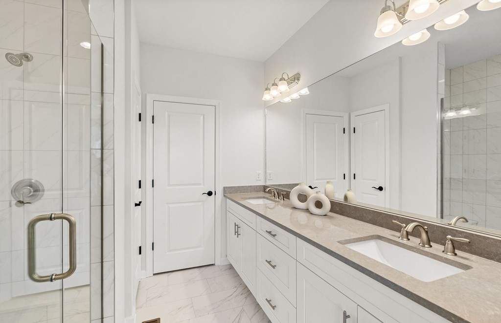 2 Cooley Drive, Unit 15 Woburn, MA 01801 - Photo 16 of 34 a bathroom with double vanity sinks a vanity a mirror and shower