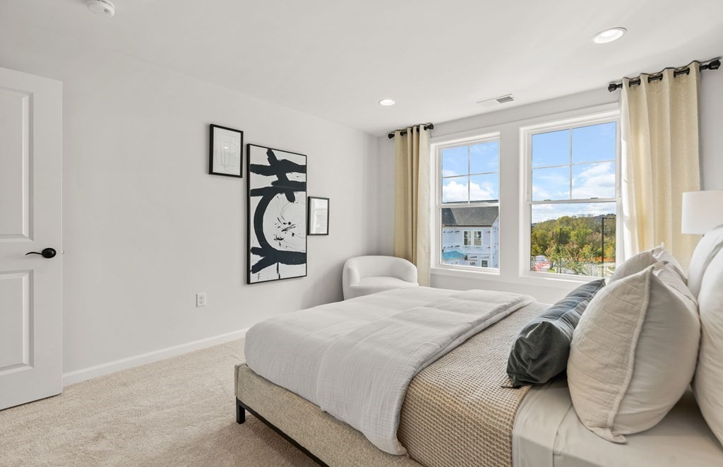 2 Cooley Drive, Unit 15 Woburn, MA 01801 - Photo 27 of 34 a bedroom with a bed and a painting on the wall