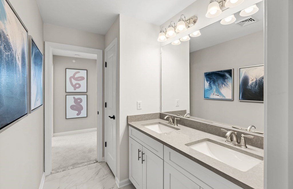 2 Cooley Drive, Unit 15 Woburn, MA 01801 - Photo 28 of 34 a bathroom with a double vanity sink and a mirror