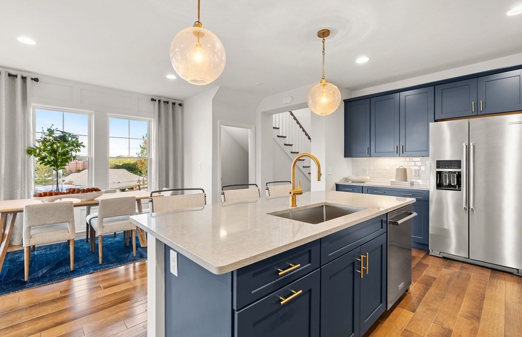 2 Cooley Drive, Unit 15 Woburn, MA 01801 - Photo 4 of 34 a kitchen with granite countertop a sink a counter space cabinets and stainless steel appliances