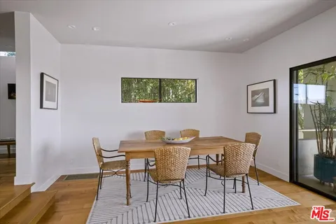 a patio with yard glass top table and chairs