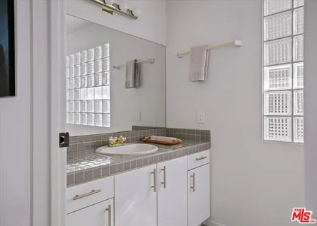 a bathroom with a granite countertop sink a mirror and a