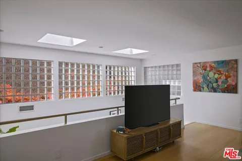 a bedroom with a bed a couch and a window