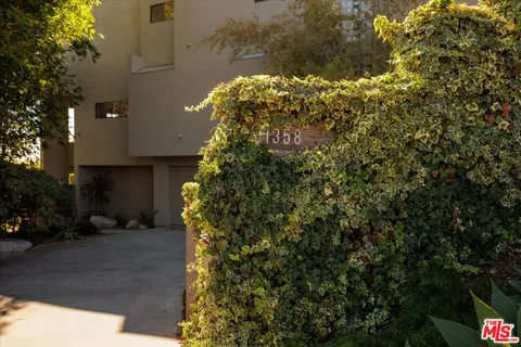 a view of room with furniture and potted plants