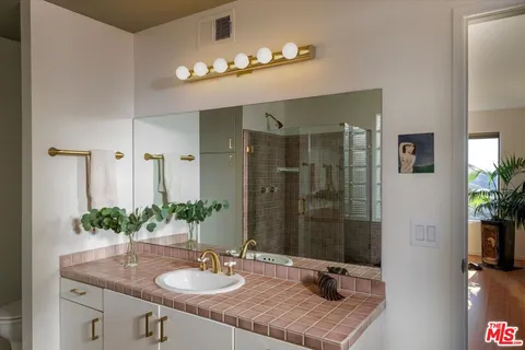 a kitchen with granite countertop a sink and cabinets