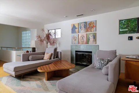 a living room with furniture and a potted plant