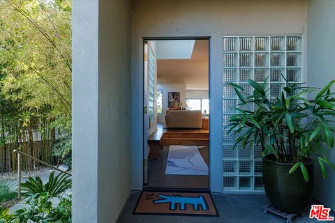 a living room with furniture a fireplace and a wall painting