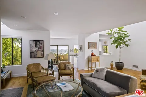 a view of a livingroom with furniture window and wooden floor