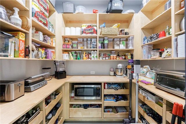 a view of a roof deck with table and chairs with wooden floor and fence
