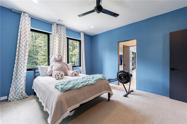 a view of a room with gym equipment and a flat screen tv