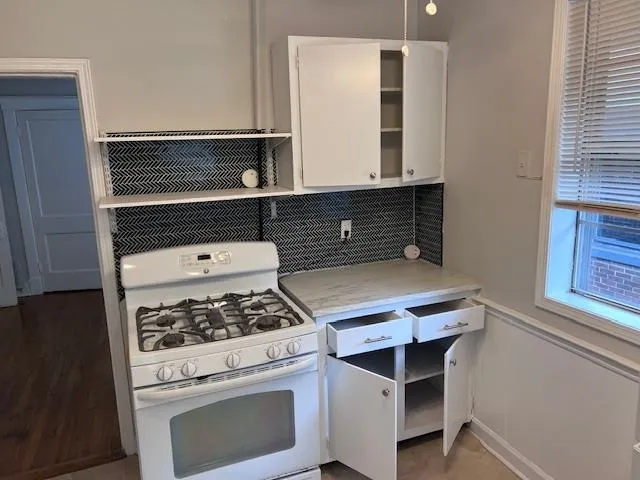 a kitchen with a stove and a microwave