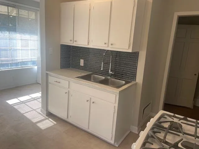a kitchen with a sink and cabinets