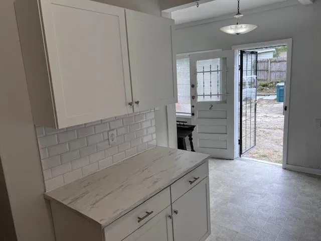 wooden floor in an empty room and a kitchen