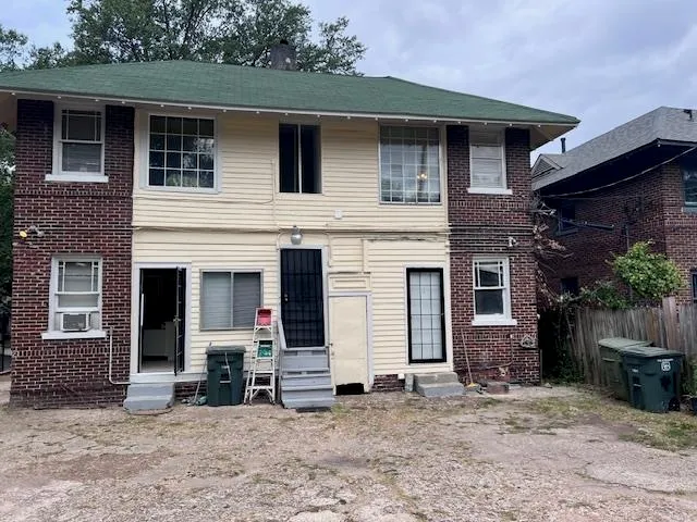 a view of a house with a yard and seating space