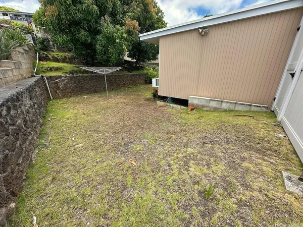 a backyard of a house with chairs