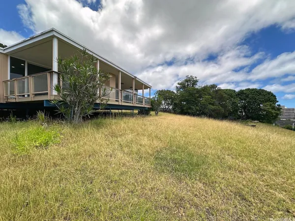 a view of a house with a yard from a tub