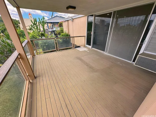 a view of outdoor space with wooden floor and windows