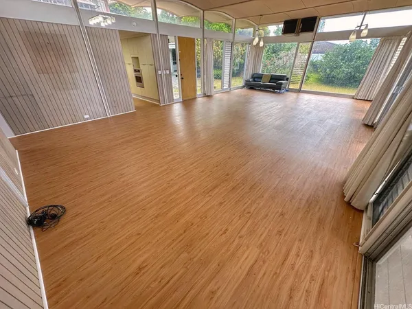 a view of a hallway with wooden floor