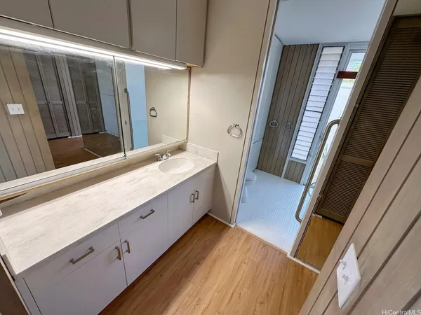 a bathroom with a double vanity sink and a mirror