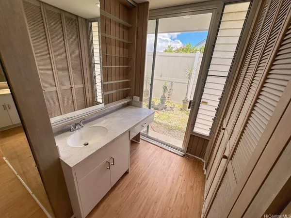 a bathroom with a sink a mirror and a shower