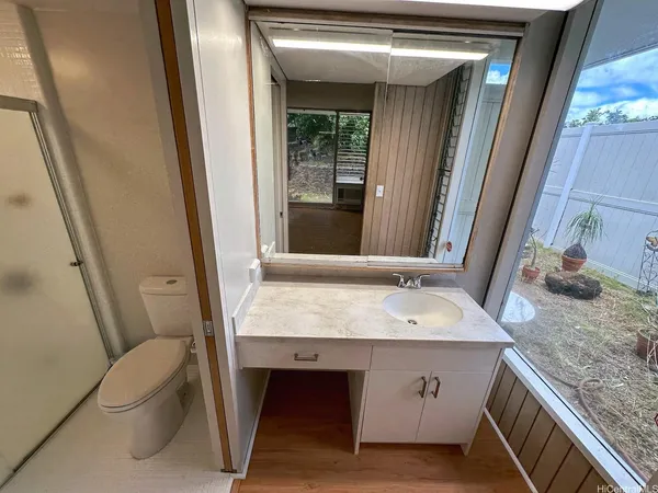 a bathroom with a granite countertop sink and a mirror