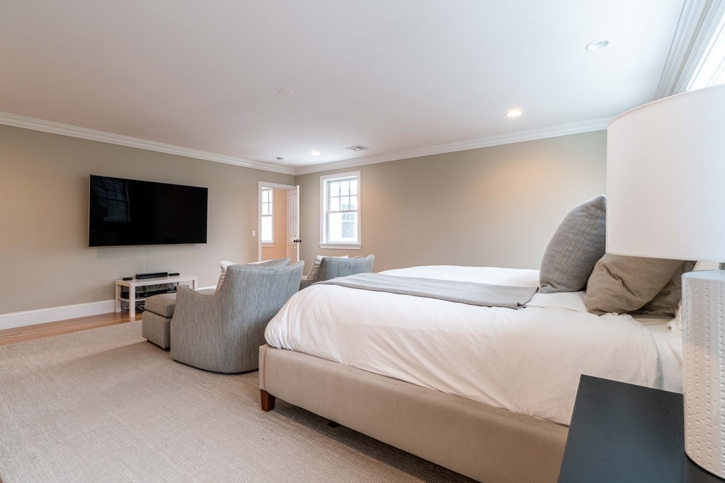 157 Walpole Street Dover, MA 02030 - Photo 23 of 38 a bedroom with a bed and a flat screen tv