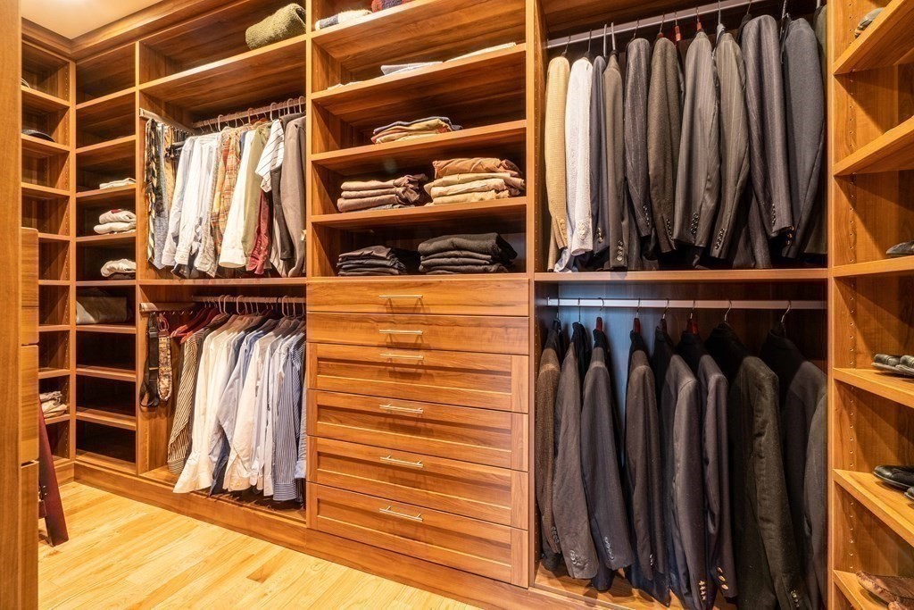 157 Walpole Street Dover, MA 02030 - Photo 24 of 38 a view of walk in closet with clothes and shoes