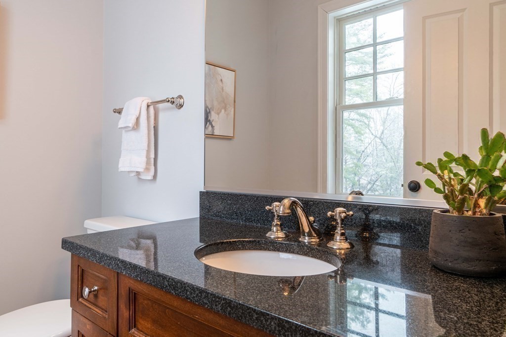 157 Walpole Street Dover, MA 02030 - Photo 31 of 38 a bathroom with a granite countertop sink a mirror and a window