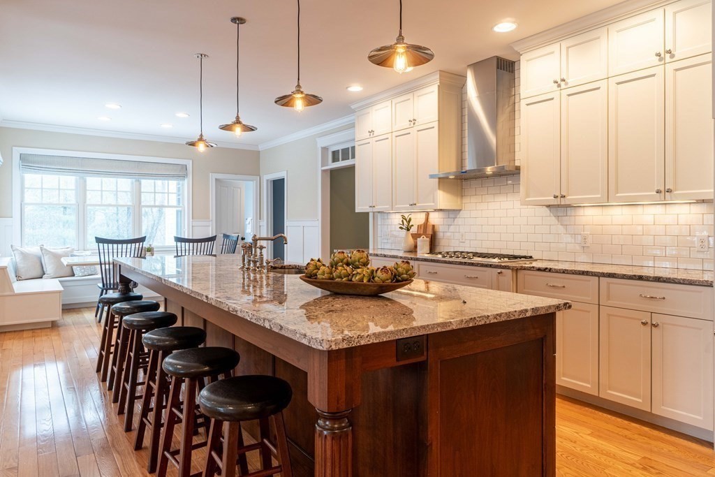 157 Walpole Street Dover, MA 02030 - Photo 6 of 38 a kitchen with stainless steel appliances granite countertop a stove a sink a dining table and chairs with wooden floor
