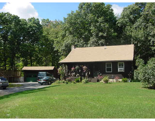 89 Cutler Road Warren, MA 01083 - Photo 1 of 2 a view of a house with backyard sitting area and garden
